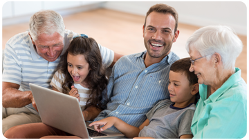 A family watching their digitized home movies together on a couch
